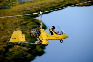 Gyroplanes are legal to fly in the US, like this one flying over water